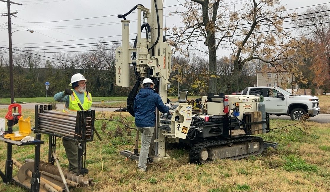 Geotechnical field investigation — drilling rig and subsurface testing on an active construction site